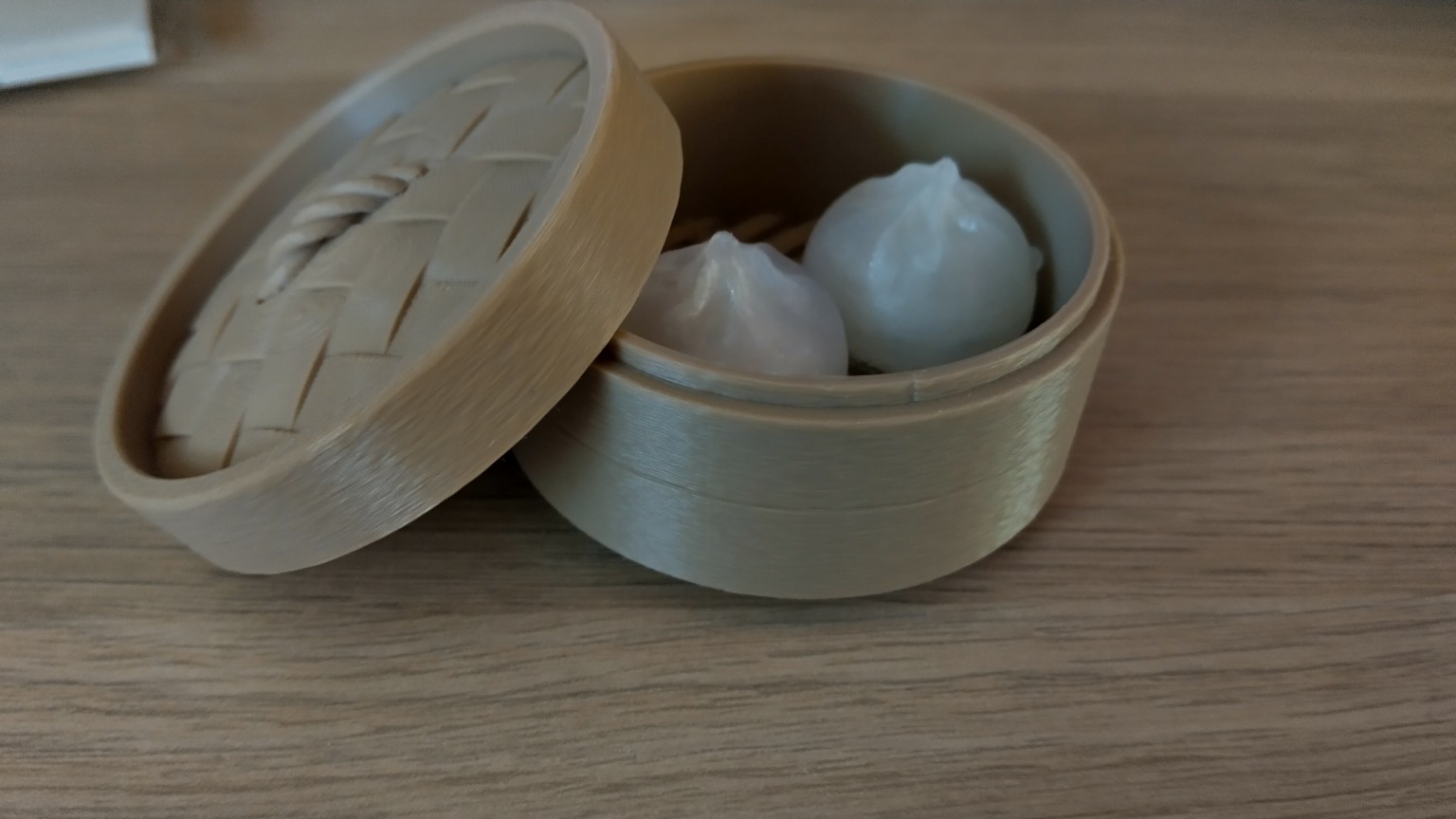 3D-printed bamboo steamer with dumplings
